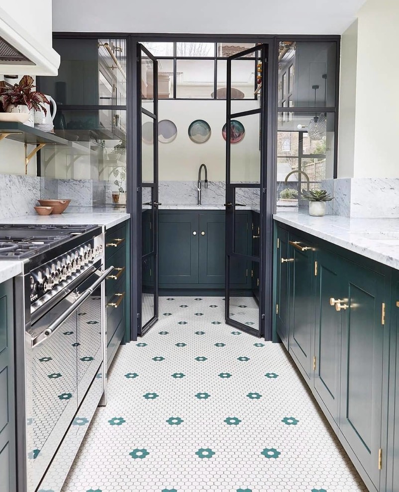 Inspiration for a transitional u-shaped separate kitchen in London with shaker cabinets, green cabinets, grey splashback and grey benchtop.