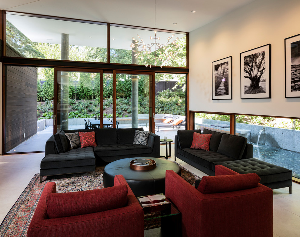 Photo of a modern living room in Seattle with porcelain floors, a two-sided fireplace and a metal fireplace surround.