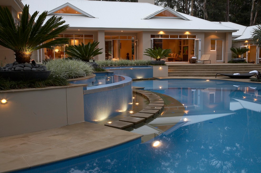 Photo of a large contemporary backyard custom-shaped pool in Sydney.