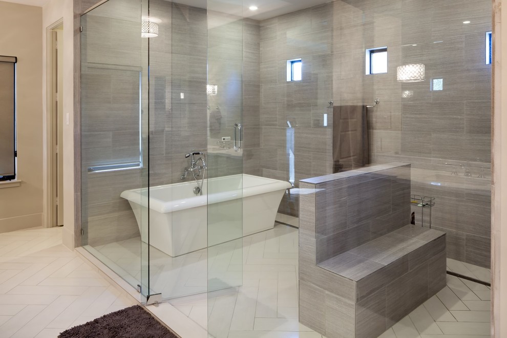 Design ideas for a transitional master bathroom in Houston with a freestanding tub, a shower/bathtub combo, gray tile, grey walls, white floor and a hinged shower door.
