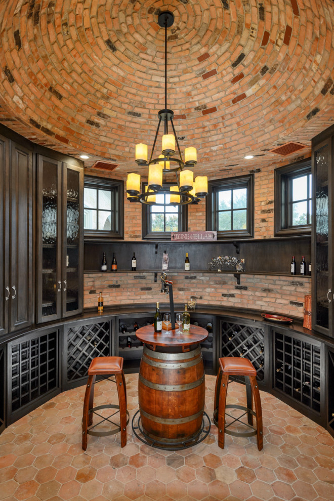 This is an example of a mid-sized traditional wine cellar in Dallas with terra-cotta floors, storage racks and orange floor.