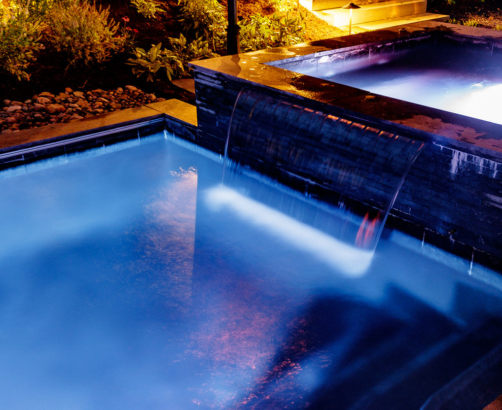 Inspiration for a backyard stone and rectangular hot tub remodel