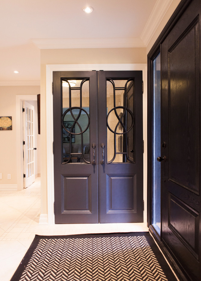 Design ideas for a mid-sized transitional foyer in Toronto with beige walls, ceramic floors, a double front door and a dark wood front door.