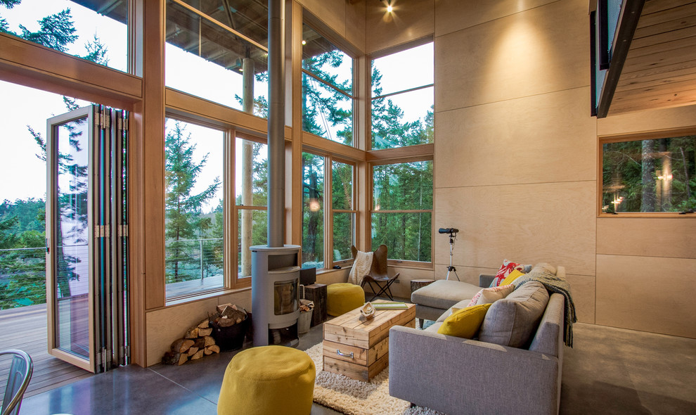 Mid-sized country formal open concept living room in Seattle with beige walls, concrete floors, a wood stove, a metal fireplace surround and no tv.