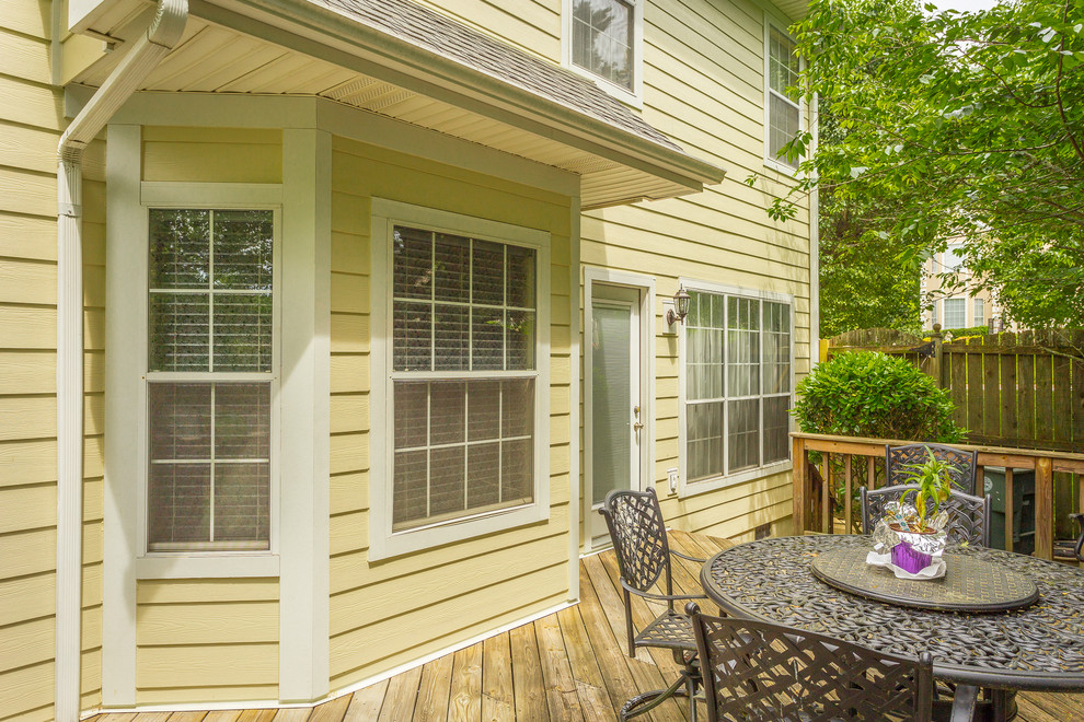 Mid-sized elegant side yard deck photo with no cover