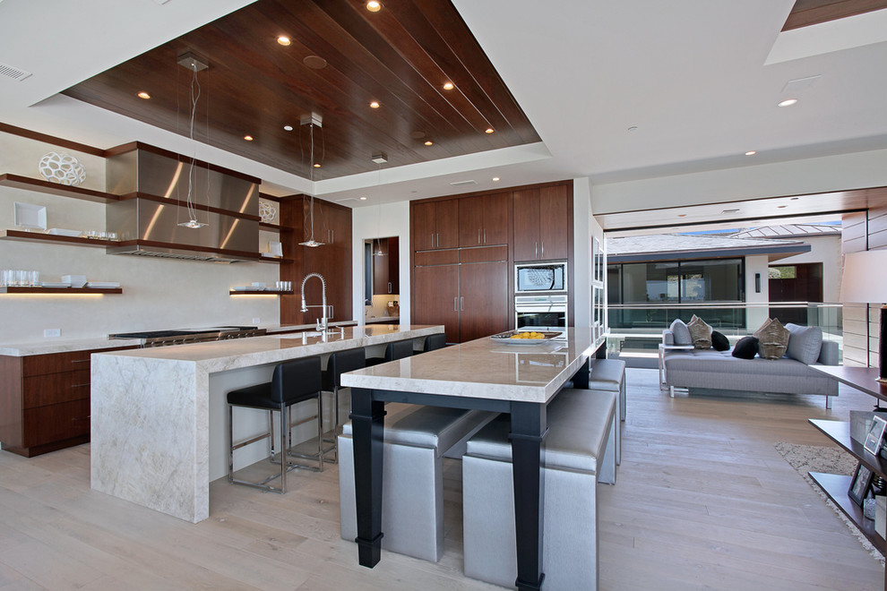 Design ideas for a contemporary open plan kitchen in Orange County with dark wood cabinets, quartzite benchtops, beige splashback, stainless steel appliances, flat-panel cabinets and a single-bowl sink.