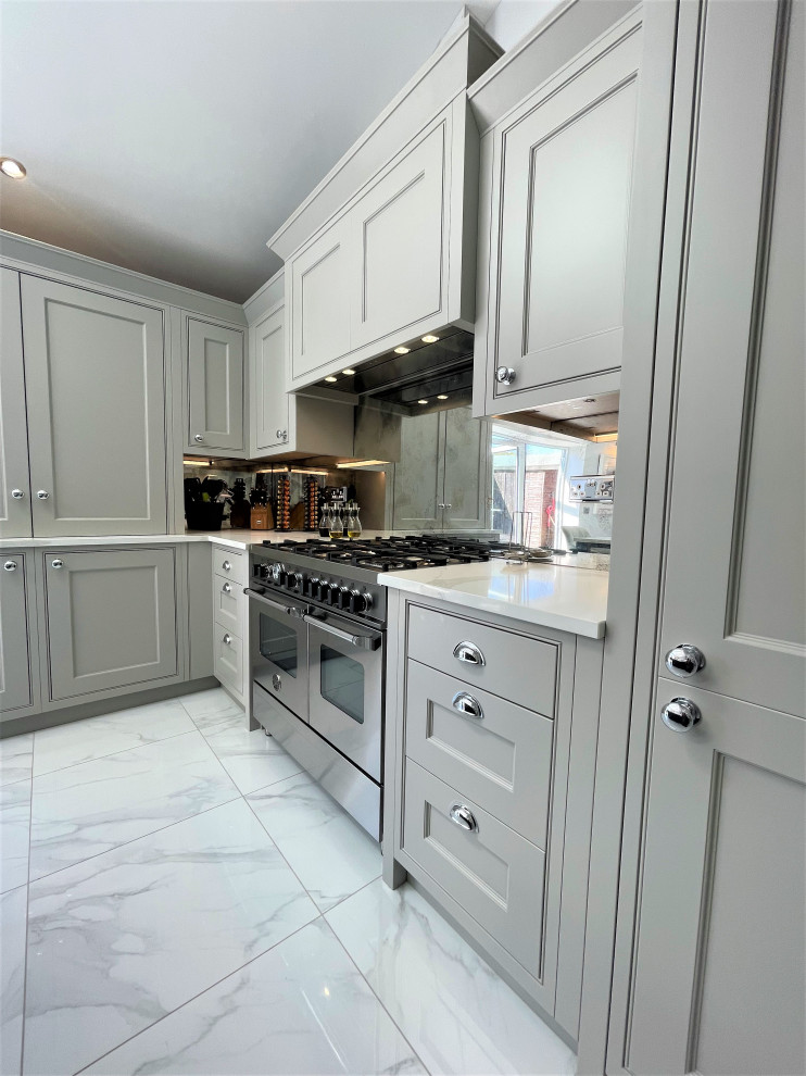 Medium sized classic l-shaped kitchen/diner in Other with raised-panel cabinets, medium wood cabinets, engineered stone countertops, glass sheet splashback, stainless steel appliances, porcelain flooring and an island.