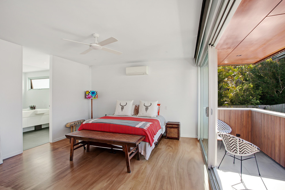 Contemporary bedroom in Sunshine Coast with white walls and medium hardwood floors.