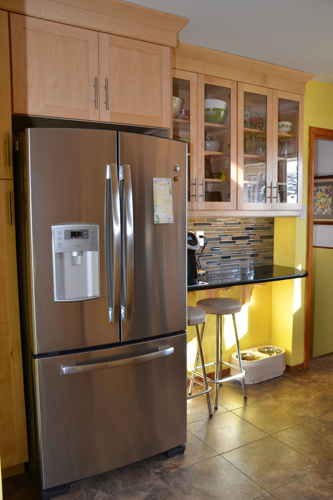 Open concept kitchen - l-shaped vinyl floor open concept kitchen idea in Toronto with an undermount sink, shaker cabinets, light wood cabinets, quartzite countertops, multicolored backsplash, mosaic tile backsplash, stainless steel appliances and an island