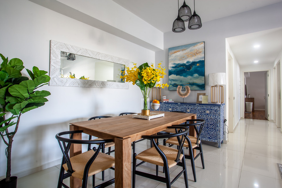 Inspiration for a beach style dining room in Singapore with white walls and white floor.