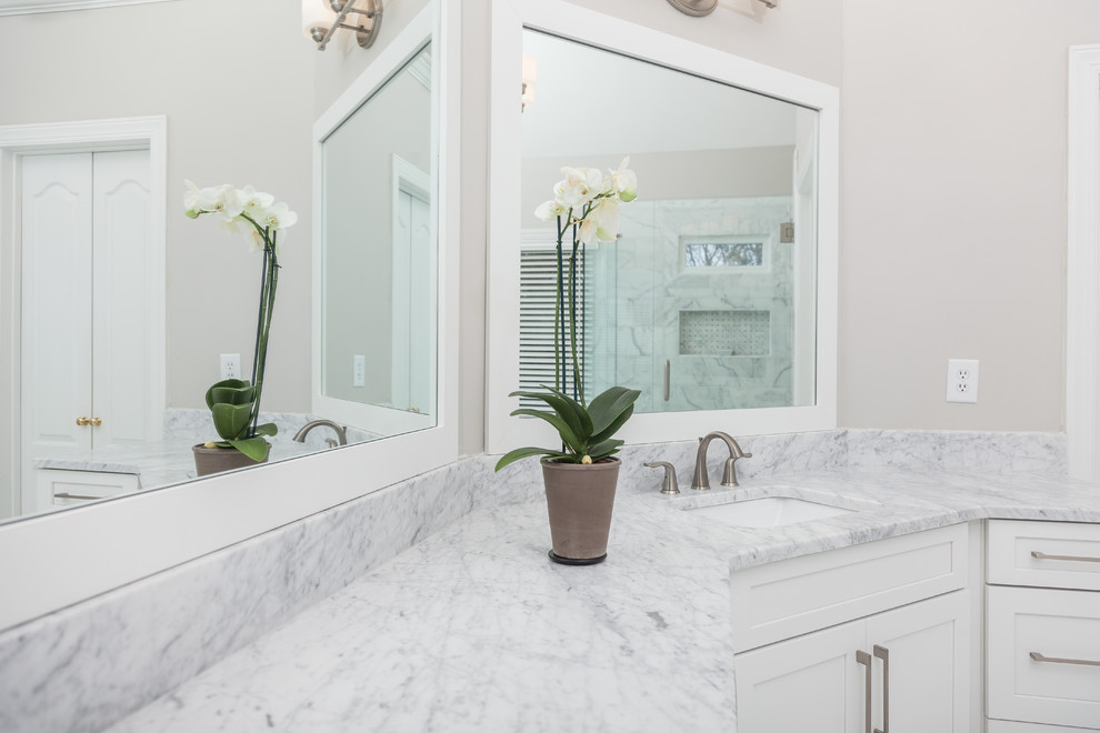 Large contemporary master bathroom in Atlanta with shaker cabinets, white cabinets, an undermount tub, a two-piece toilet, gray tile, marble, beige walls, marble floors, an undermount sink, marble benchtops, white floor, a hinged shower door and grey benchtops.