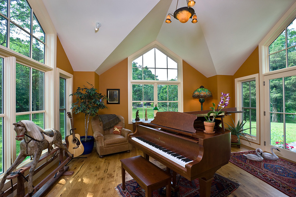This is an example of a contemporary family room in Boston with a music area.