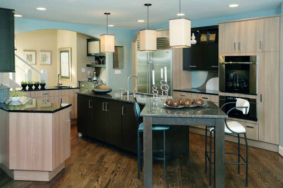 Transitional medium tone wood floor kitchen photo in Indianapolis with a drop-in sink, black cabinets, multicolored backsplash, stainless steel appliances and an island