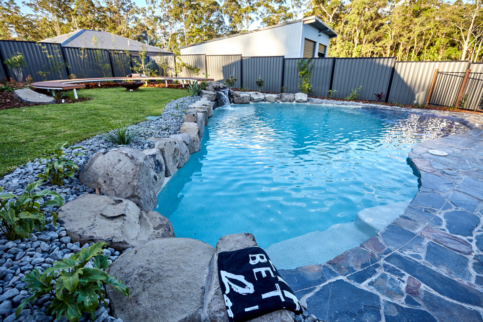 Design ideas for a beach style backyard custom-shaped pool in Sunshine Coast.