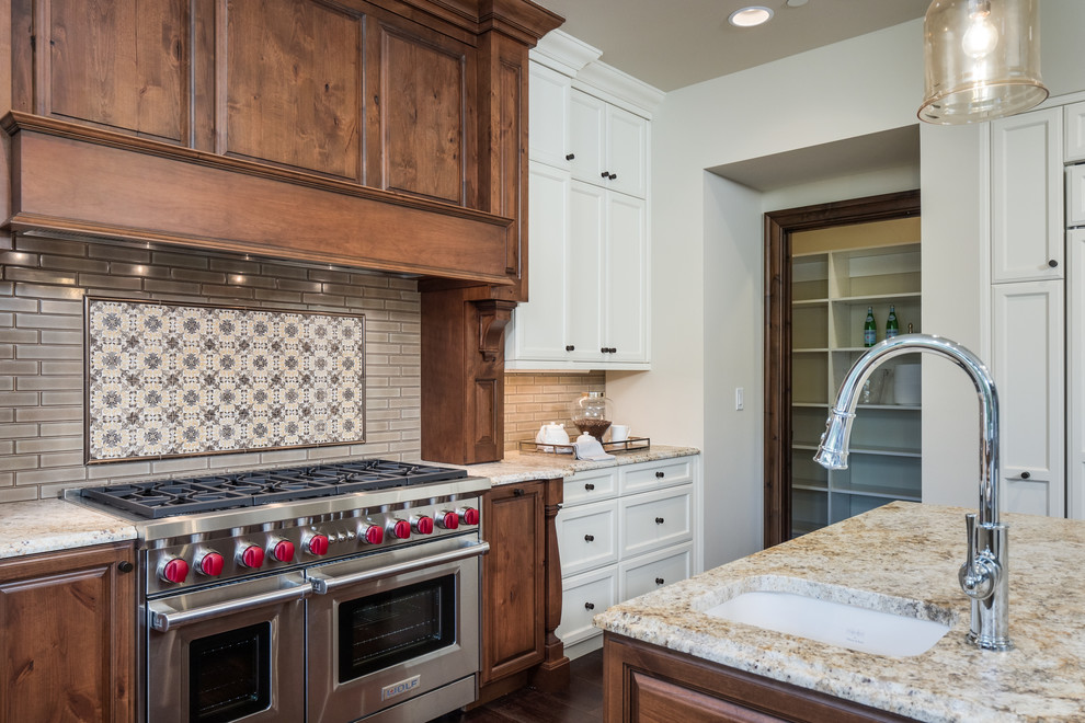 This is an example of a traditional kitchen in Seattle with shaker cabinets, white cabinets, panelled appliances and with island.