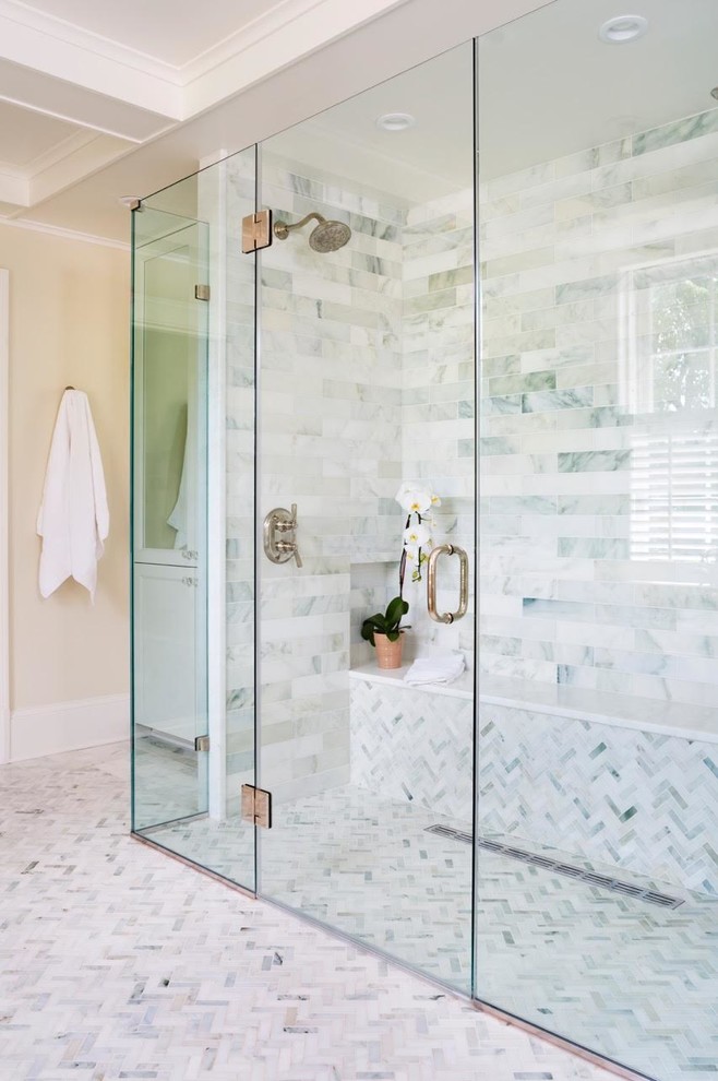 Photo of a large transitional master bathroom in DC Metro with recessed-panel cabinets, white cabinets, a freestanding tub, a curbless shower, white tile, beige walls, mosaic tile floors, an integrated sink and quartzite benchtops.