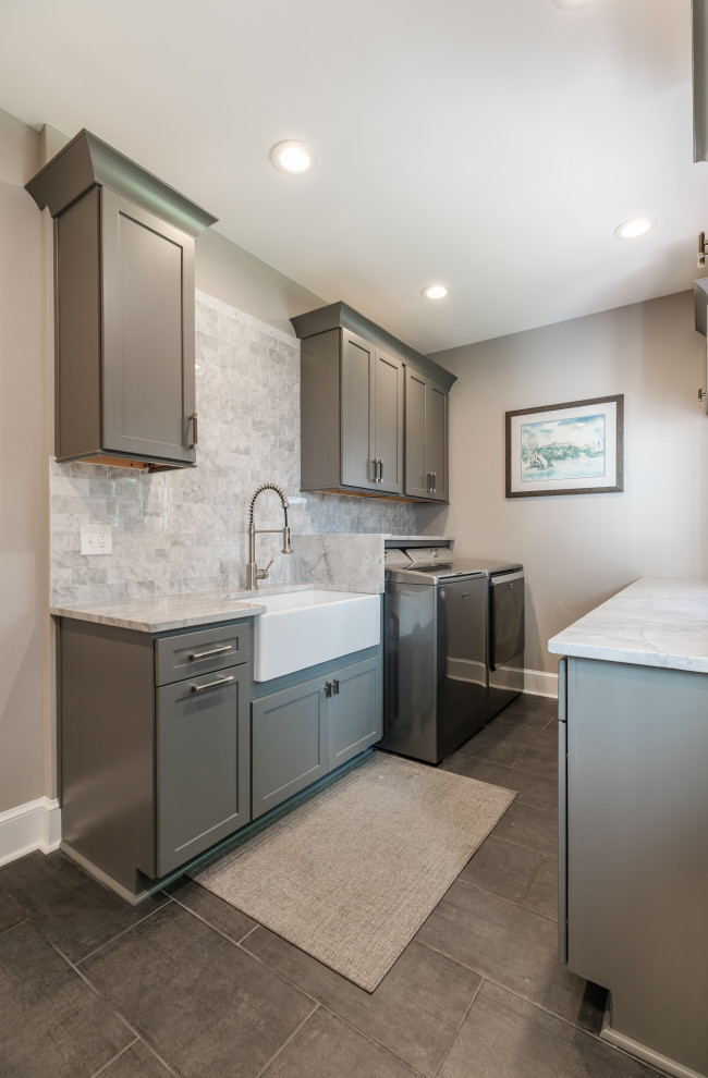 Photo of a mid-sized contemporary u-shaped utility room in DC Metro with an undermount sink, beaded inset cabinets, grey cabinets, quartzite benchtops, grey splashback, grey walls, a side-by-side washer and dryer, grey floor and grey benchtop.