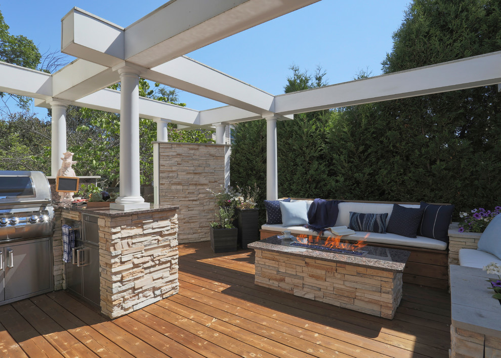 Outdoor kitchen deck - huge transitional backyard outdoor kitchen deck idea in Chicago with a pergola