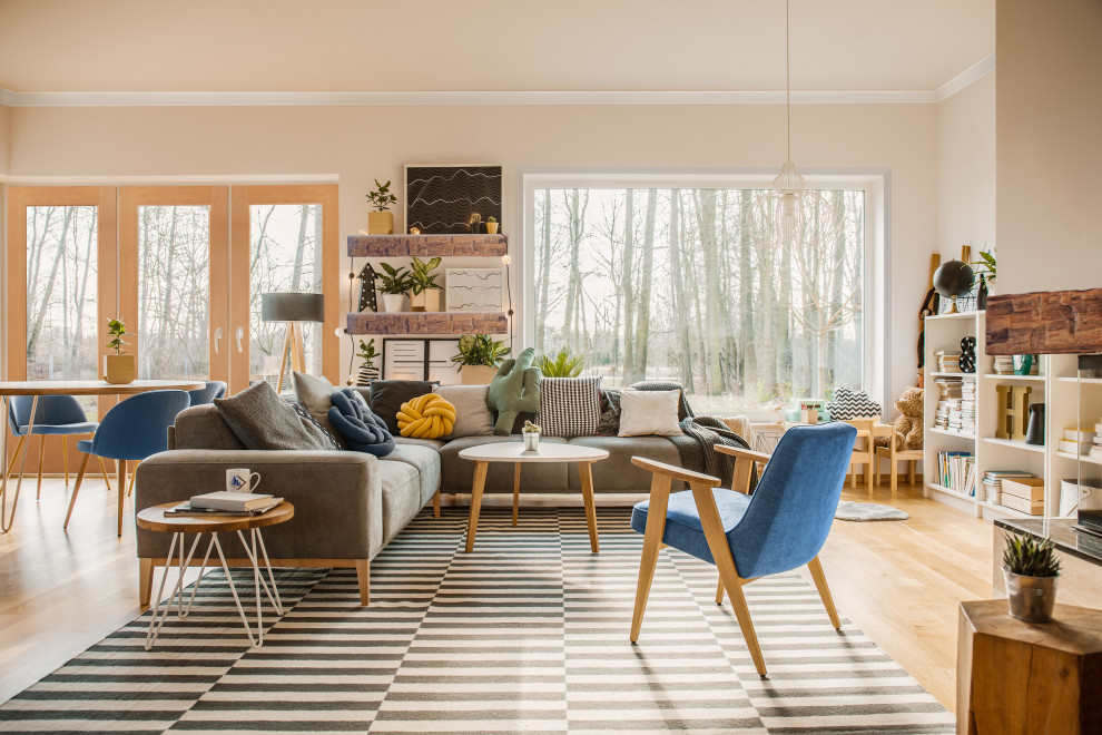 Idee per un grande soggiorno contemporaneo aperto con pareti beige, pavimento in legno massello medio, camino bifacciale e pavimento marrone