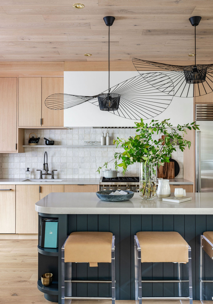Medium sized modern kitchen/diner in Toronto with a submerged sink, flat-panel cabinets, light wood cabinets, engineered stone countertops, white splashback, stone tiled splashback, stainless steel appliances, light hardwood flooring, an island, beige floors, grey worktops and a wood ceiling.
