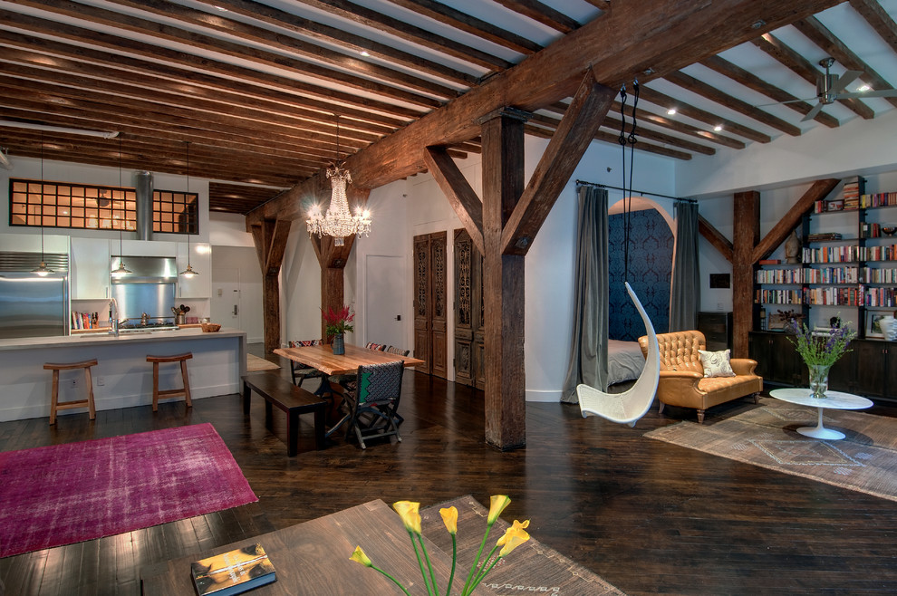 Mid-sized industrial open concept living room in New York with dark hardwood floors.