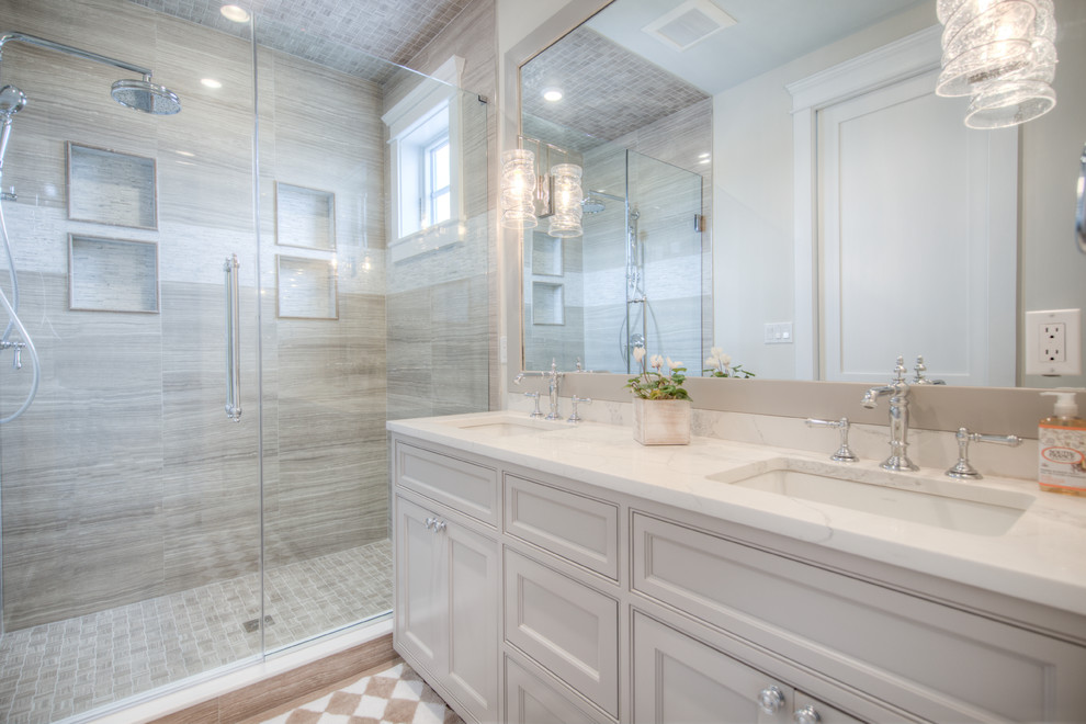 Mid-sized transitional master beige tile, brown tile, white tile and porcelain tile porcelain tile and multicolored floor alcove shower photo with shaker cabinets, white cabinets, beige walls, an undermount sink, quartz countertops and a hinged shower door