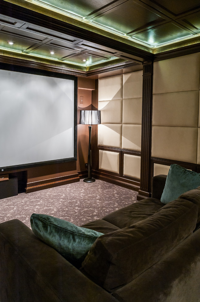 Traditional enclosed home theatre in Other with beige walls, carpet, a projector screen and brown floor.