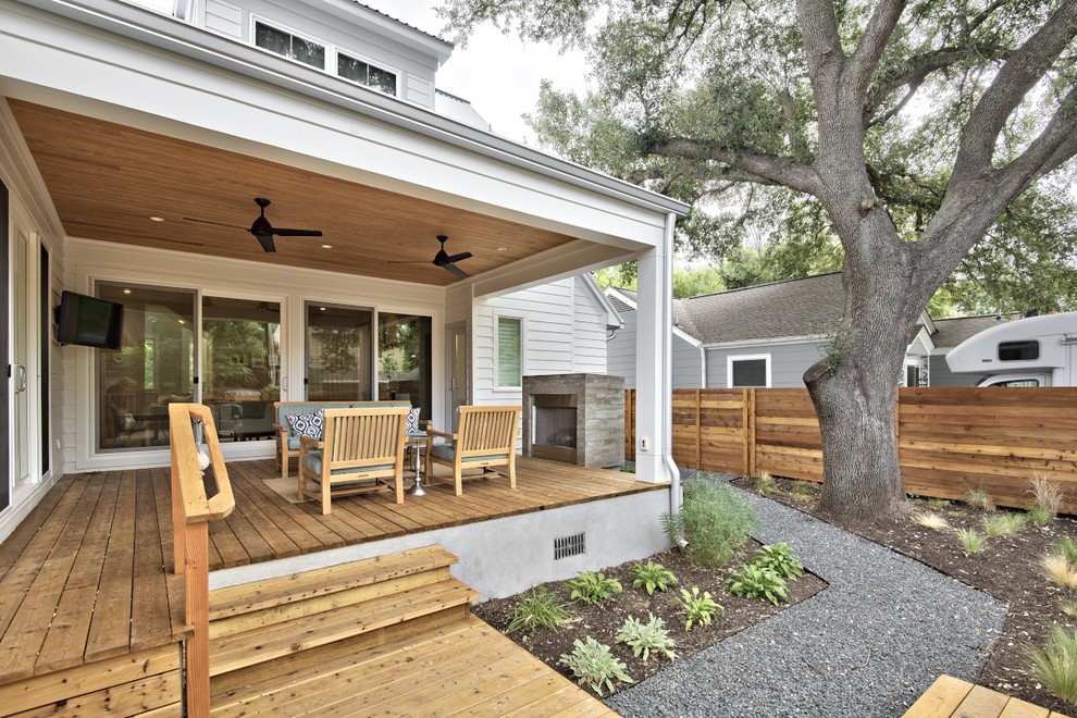 Example of a transitional backyard deck design in Austin with a fire pit