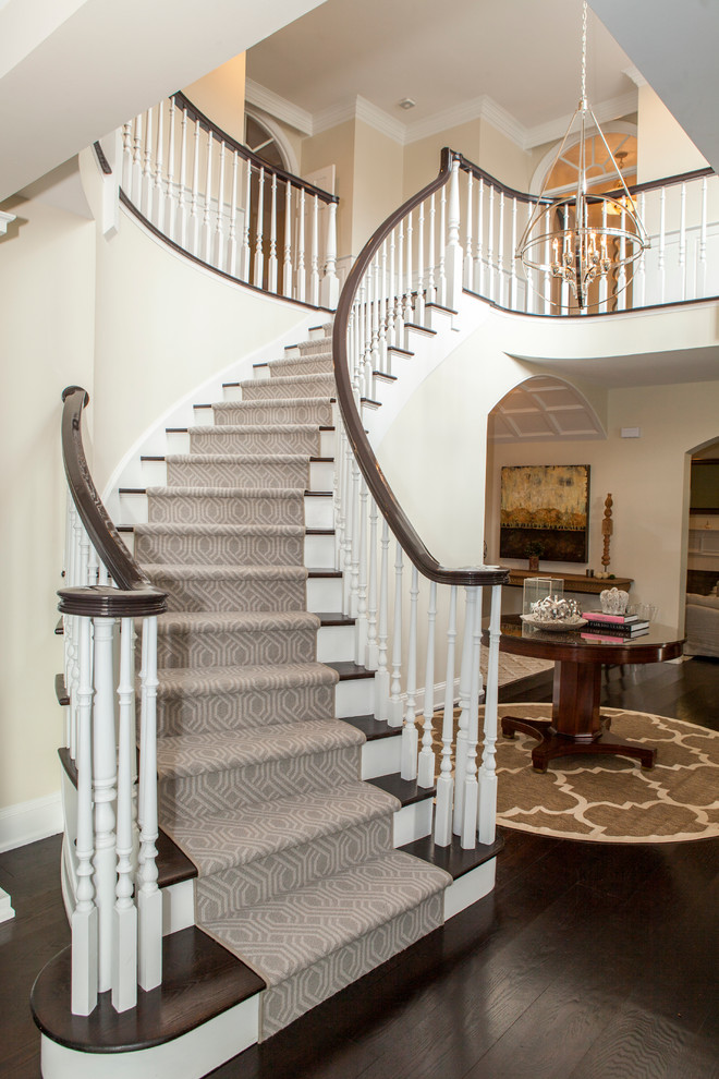 Inspiration for an expansive transitional wood curved staircase in Philadelphia with wood risers and wood railing.