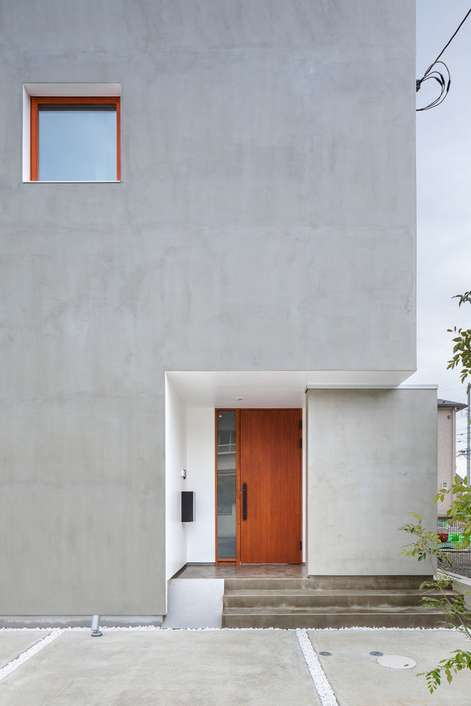 Contemporary concrete grey house exterior in Other.