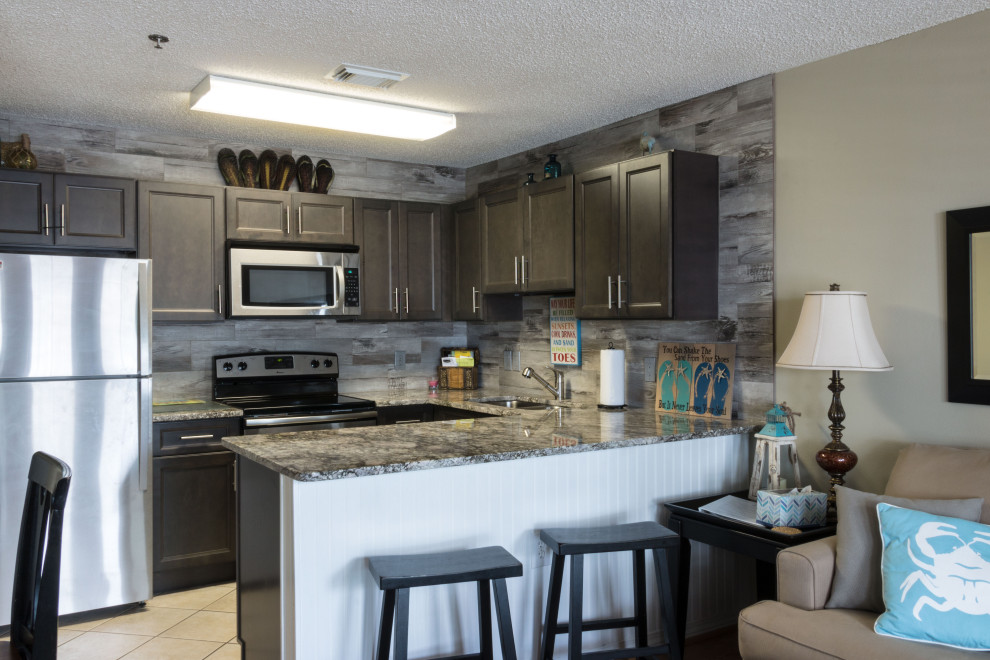 Inspiration for a small rustic u-shaped cement tile floor and beige floor eat-in kitchen remodel with an undermount sink, flat-panel cabinets, medium tone wood cabinets, granite countertops, gray backsplash, ceramic backsplash, stainless steel appliances, a peninsula and gray countertops