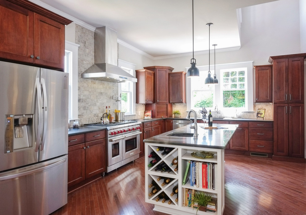 Design ideas for a large traditional l-shaped eat-in kitchen in Raleigh with an undermount sink, dark wood cabinets, glass benchtops, grey splashback, stone tile splashback, stainless steel appliances, medium hardwood floors, with island and brown floor.