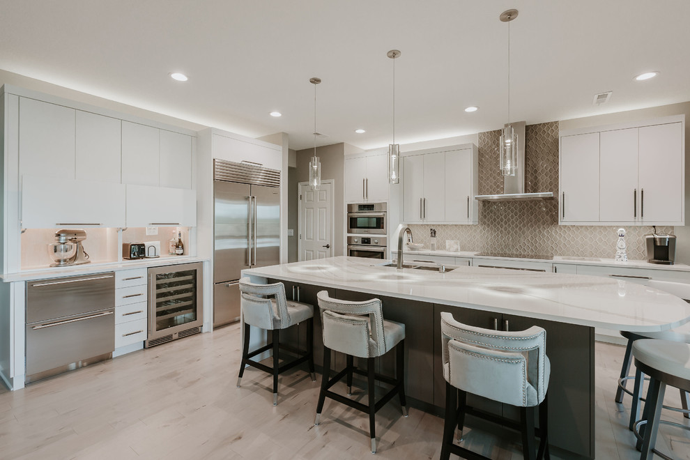 Inspiration for a mid-sized contemporary l-shaped kitchen in Other with an undermount sink, flat-panel cabinets, quartzite benchtops, grey splashback, ceramic splashback, stainless steel appliances, light hardwood floors, with island, grey benchtop, white cabinets and beige floor.