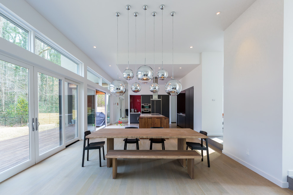 Inspiration for a large contemporary dining room in Atlanta with white walls and light hardwood floors.