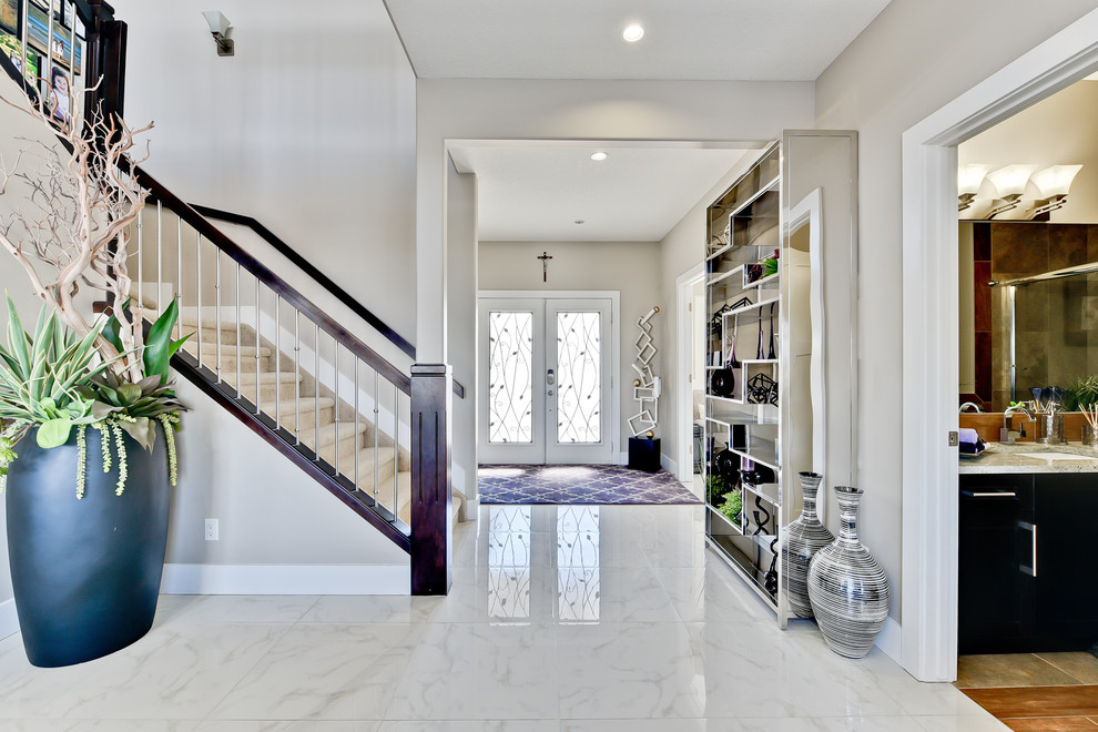 Large transitional marble floor foyer photo in Edmonton with gray walls and a white front door