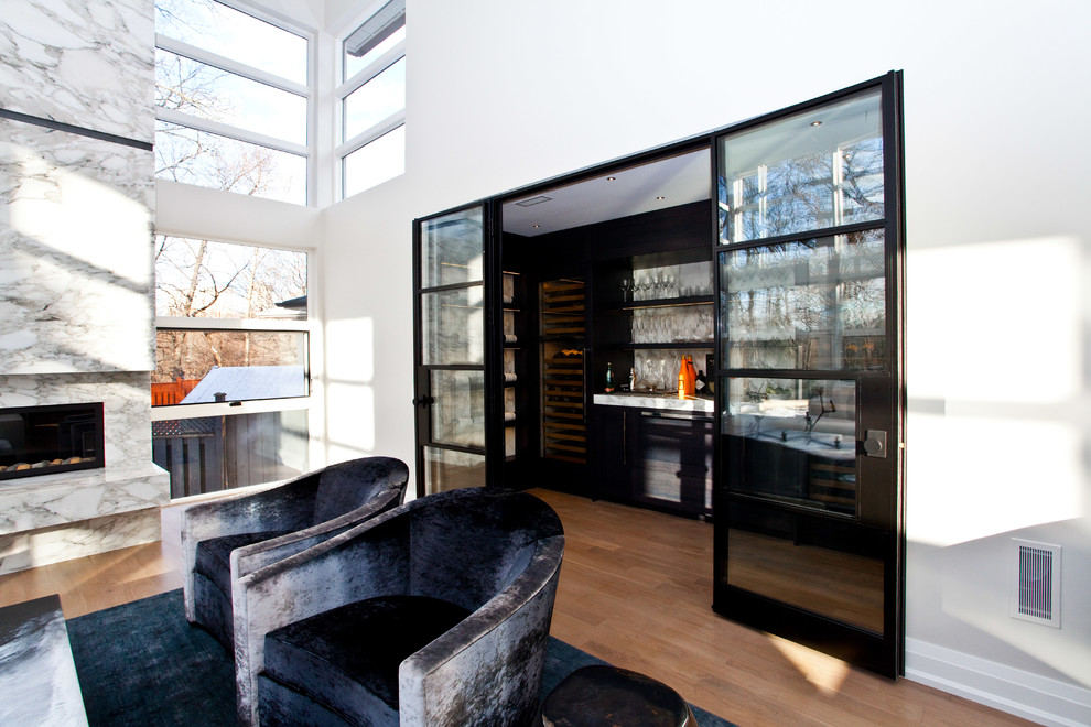 Photo of a mid-sized contemporary wine cellar in Toronto with medium hardwood floors and display racks.