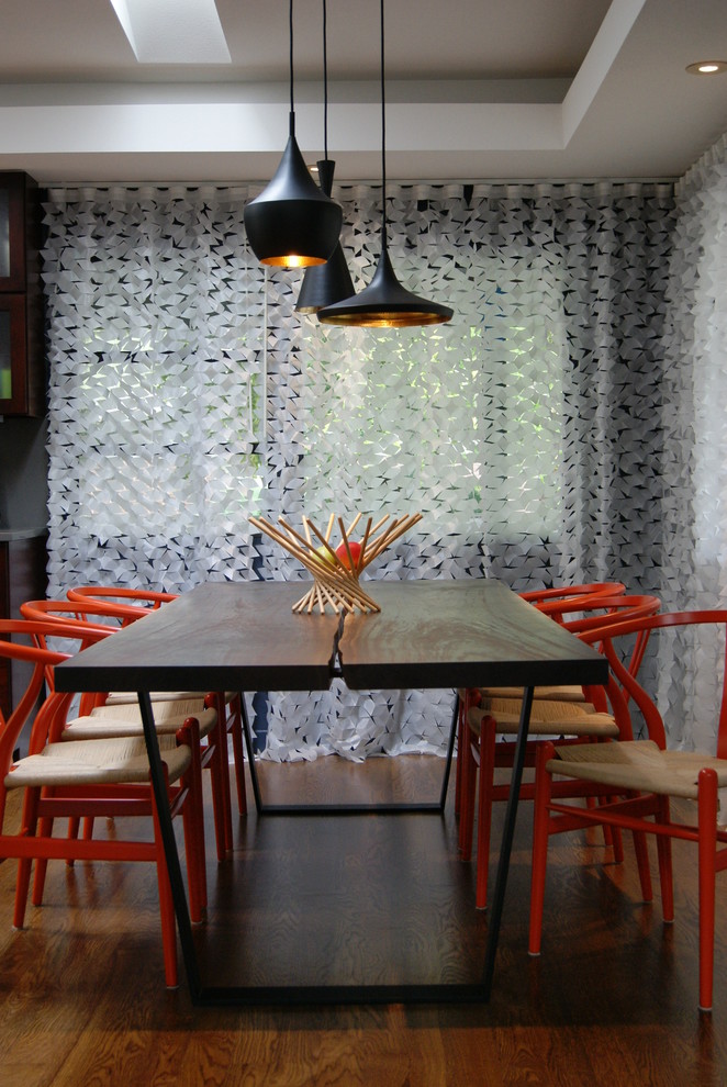 Photo of a modern dining room in Phoenix with dark hardwood floors.