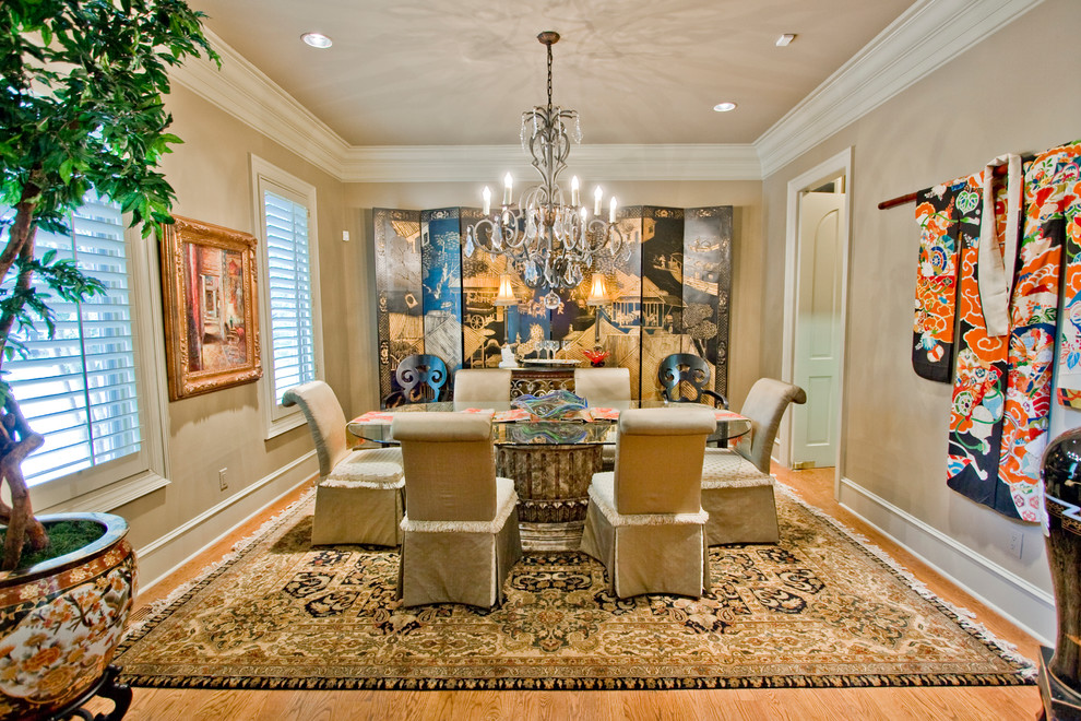This is an example of a traditional dining room in Little Rock with beige walls and medium hardwood floors.