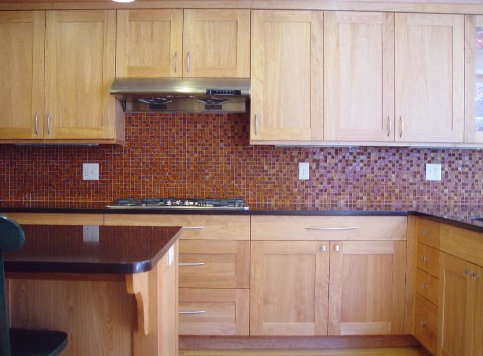 Mid-sized country eat-in kitchen in Boston with a double-bowl sink, granite benchtops, stainless steel appliances, with island, shaker cabinets, light wood cabinets, multi-coloured splashback and mosaic tile splashback.