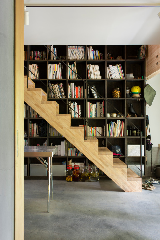 This is an example of a mid-sized industrial staircase in Other with wood walls.
