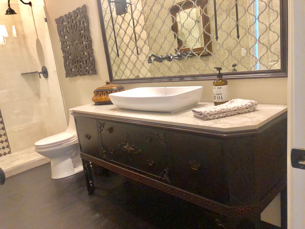 Inspiration for a mid-sized transitional bathroom in San Diego with furniture-like cabinets, dark wood cabinets, an open shower, a one-piece toilet, mirror tile, beige walls, dark hardwood floors, a vessel sink, quartzite benchtops, brown floor, an open shower and white benchtops.