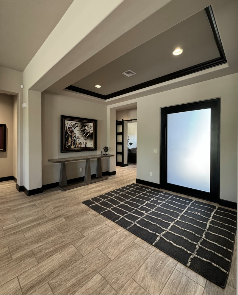 Example of a mid-sized transitional porcelain tile, beige floor and coffered ceiling foyer design in Phoenix with beige walls and a metal front door