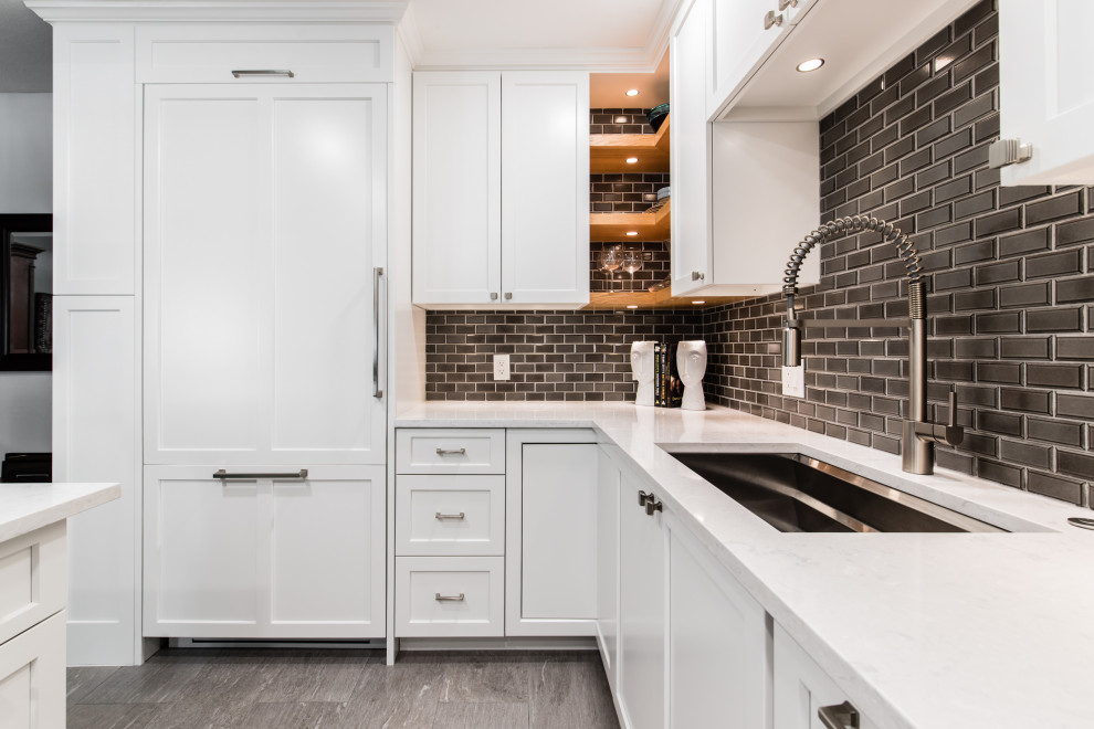 Inspiration for a small transitional u-shaped eat-in kitchen in Dallas with shaker cabinets, white cabinets, quartz benchtops, brown splashback, porcelain splashback, stainless steel appliances, porcelain floors, with island, multi-coloured floor and white benchtop.