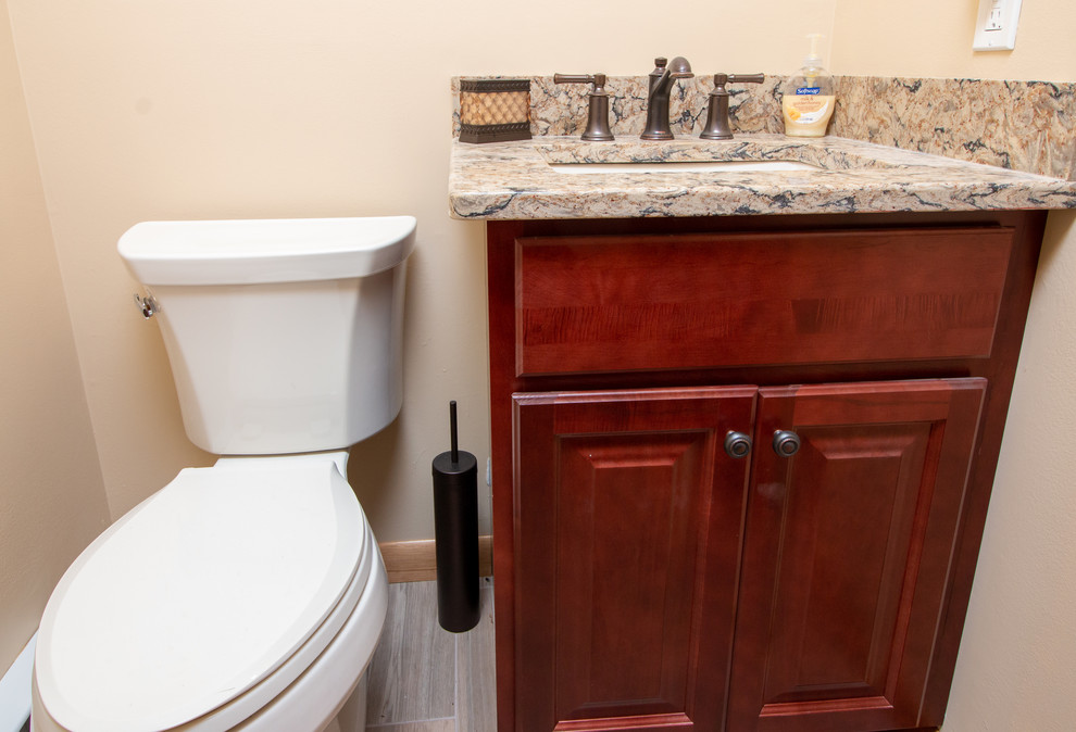 This is an example of a small transitional 3/4 bathroom in Boston with raised-panel cabinets, red cabinets, yellow walls, porcelain floors, an undermount sink, engineered quartz benchtops, brown floor and multi-coloured benchtops.