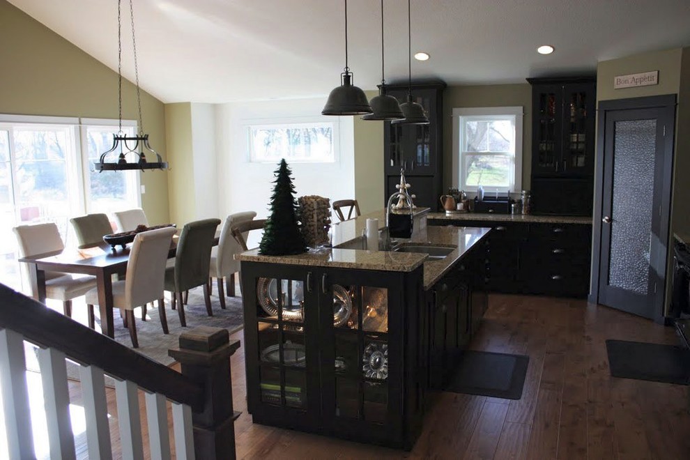 Kitchen - mid-sized l-shaped light wood floor kitchen idea in Chicago with an undermount sink, shaker cabinets, black cabinets, granite countertops, stainless steel appliances and an island
