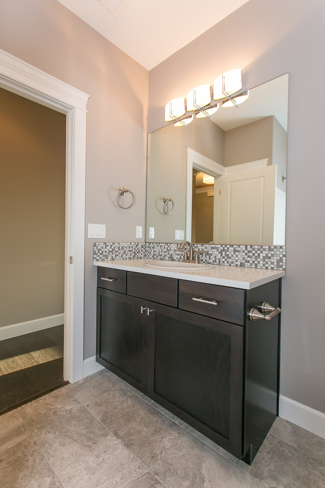 Mid-sized transitional master multicolored tile and mosaic tile porcelain tile and beige floor alcove bathtub photo in Seattle with shaker cabinets, dark wood cabinets, a two-piece toilet, gray walls, a drop-in sink and quartz countertops
