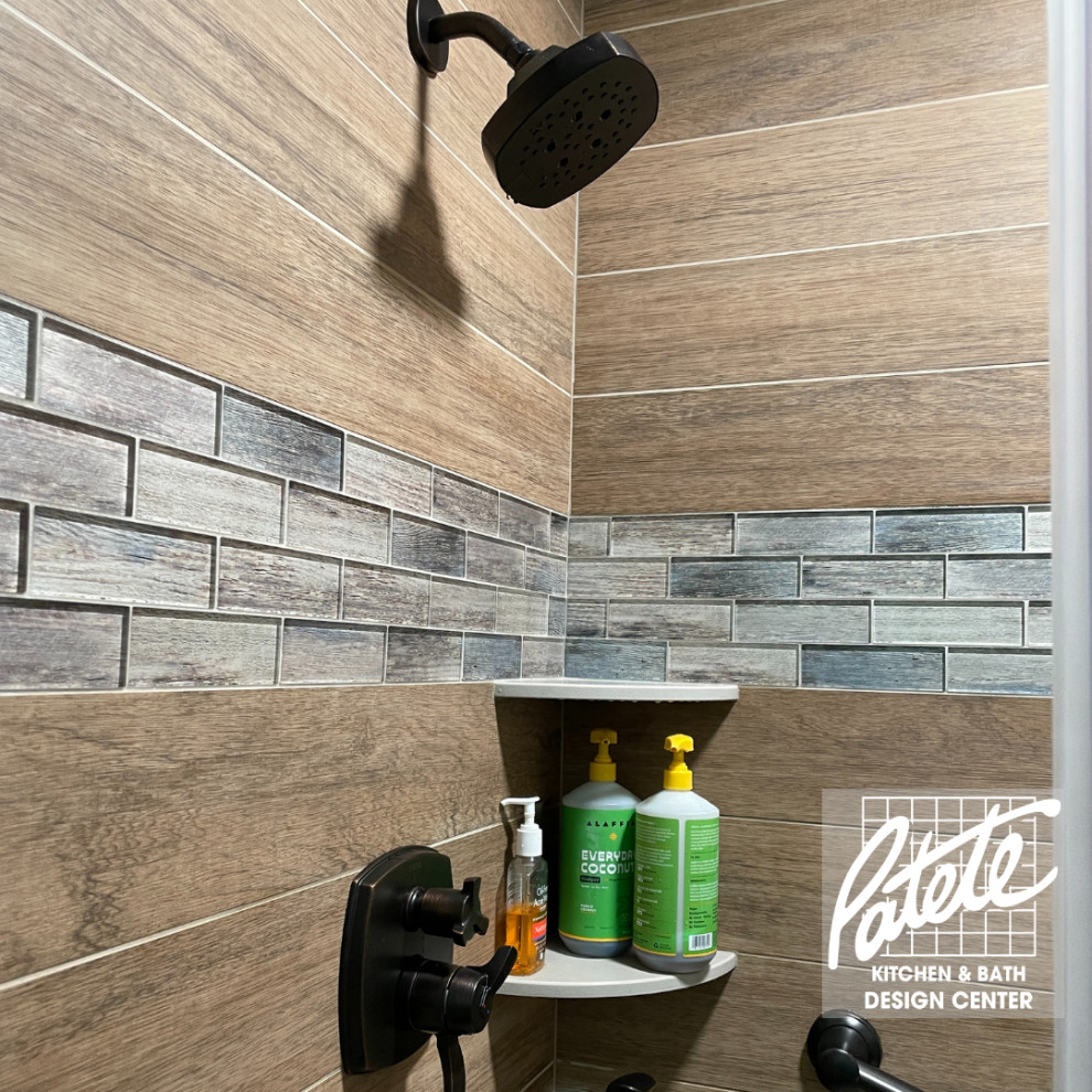 Design ideas for a modern bathroom with an alcove shower, brown tiles, wood-effect tiles, green walls, dark hardwood flooring, brown floors and a sliding door.