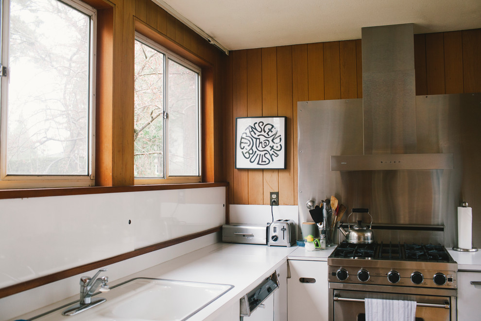 Design ideas for a small midcentury galley eat-in kitchen in Seattle with a double-bowl sink, flat-panel cabinets, white cabinets, laminate benchtops, metallic splashback, metal splashback and no island.