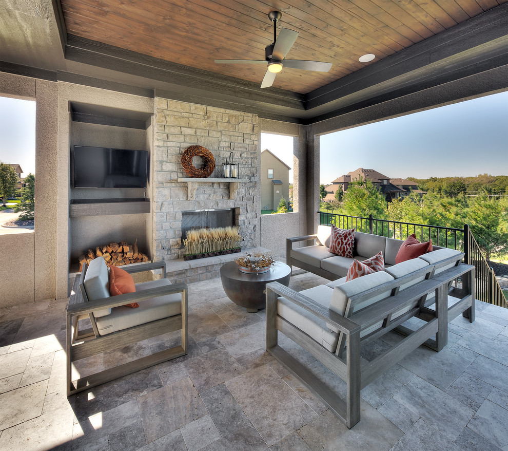 Inspiration for a transitional deck in Kansas City with with fireplace and a roof extension.
