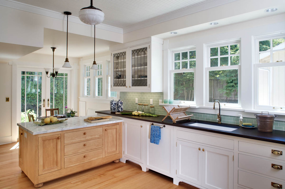 Traditional kitchen in Seattle with subway tile splashback, an undermount sink, recessed-panel cabinets, white cabinets, marble benchtops and green splashback.